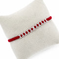 Marvel Silver red thread rakhi with polished silver-tone repeating bead cluster pattern