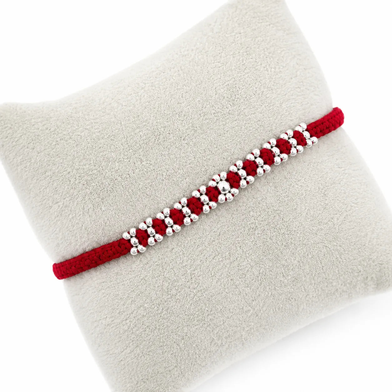Marvel Silver red thread rakhi with polished silver-tone repeating bead cluster pattern