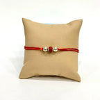 Marvel Silver Rudraksha Rakhi featuring a sacred Rudraksha bead, premium silver beads, and a traditional red-orange thread for Raksha Bandhan celebration.