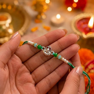 Shiv Ling Silver Rakhi with Green Crystal Beads