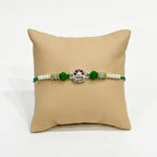 Marvel Silver Shiv Ling Silver Rakhi with Green Crystal Beads, White Pearl Beads and Sparkling Shiv Ling Charm for Raksha Bandhan