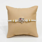 Marvel Silver Shiv Silver Rakhi with White Crystal Beads, Pearl Beads and Silver Shiv Symbol for Raksha Bandhan