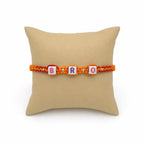 Marvel Silver BRO Letter Bead Designer Rakhi with colorful alphabet beads, silver spacer beads, and orange-red braided thread for Raksha Bandhan