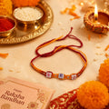 Marvel Silver BRO Letter Bead Designer Rakhi with colorful alphabet beads, silver spacer beads, and orange-red braided thread for Raksha Bandhan