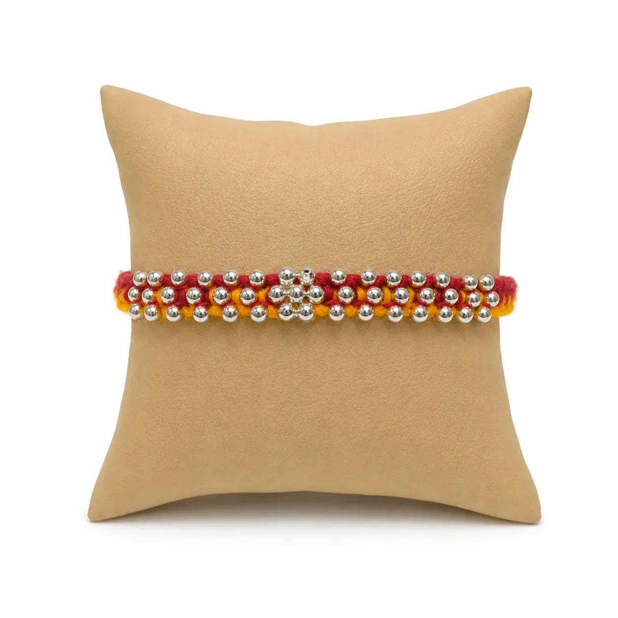 Marvel Silver Silver Bead Flower Designer Rakhi featuring a handcrafted floral silver bead centerpiece with red and yellow braided thread for Raksha Bandhan.