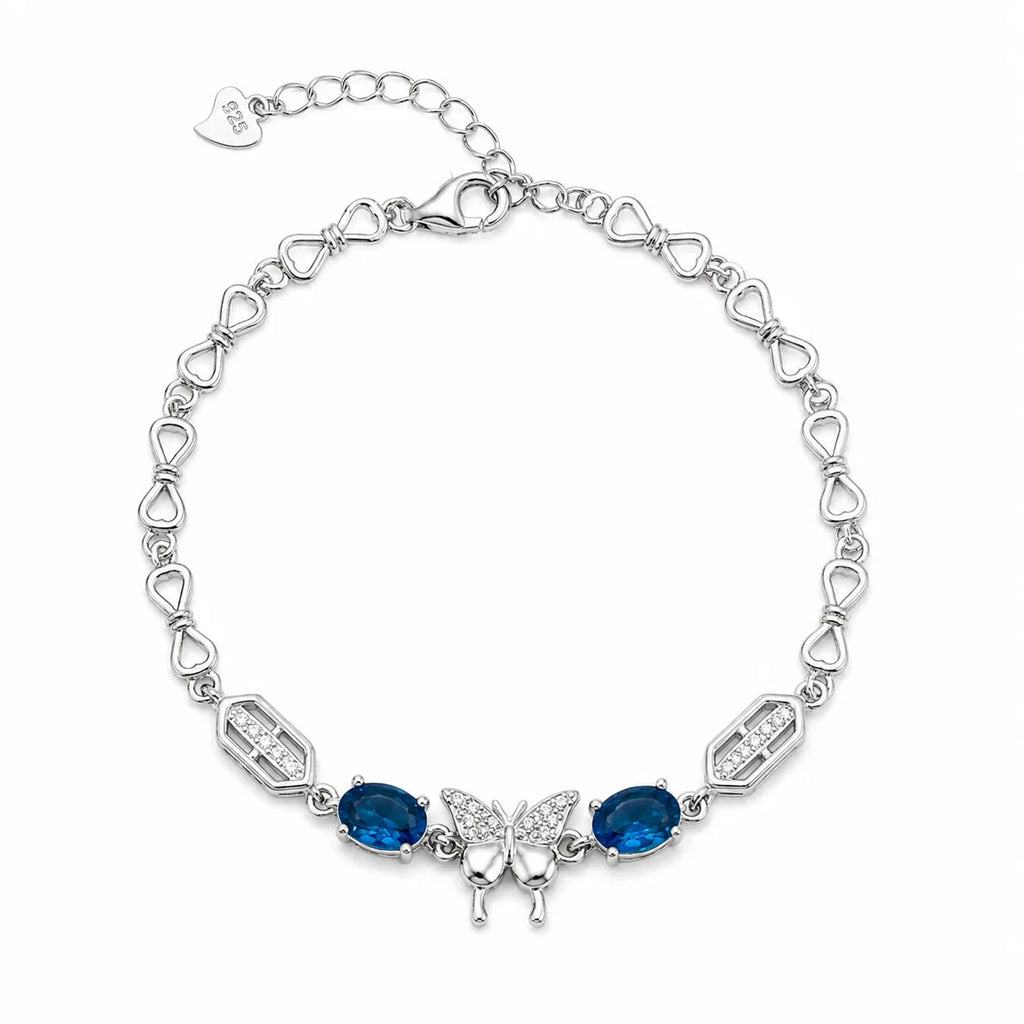 Marvel Silver 925 sterling silver bracelet featuring a sparkling butterfly centerpiece with blue gemstones, white AAA Cubic Zirconia accents, elegant heart-link chain, rhodium-plated finish, adjustable extension chain, and a stylish design for women and girls suitable for daily wear, parties, weddings, anniversaries, and gifting.