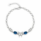 Marvel Silver 925 sterling silver bracelet featuring a sparkling butterfly centerpiece with blue gemstones, white AAA Cubic Zirconia accents, elegant heart-link chain, rhodium-plated finish, adjustable extension chain, and a stylish design for women and girls suitable for daily wear, parties, weddings, anniversaries, and gifting.