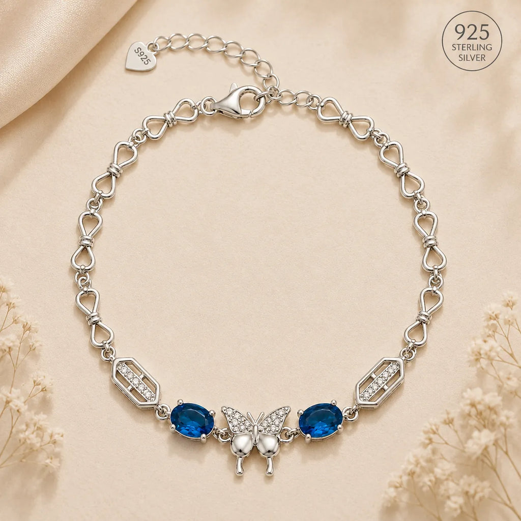 Marvel Silver 925 sterling silver bracelet featuring a sparkling butterfly centerpiece with blue gemstones, white AAA Cubic Zirconia accents, elegant heart-link chain, rhodium-plated finish, adjustable extension chain, and a stylish design for women and girls suitable for daily wear, parties, weddings, anniversaries, and gifting.