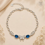 Marvel Silver 925 sterling silver bracelet featuring a sparkling butterfly centerpiece with blue gemstones, white AAA Cubic Zirconia accents, elegant heart-link chain, rhodium-plated finish, adjustable extension chain, and a stylish design for women and girls suitable for daily wear, parties, weddings, anniversaries, and gifting.