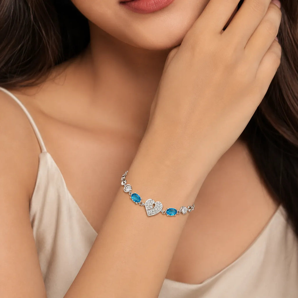 Marvel Silver 925 sterling silver bracelet featuring a sparkling heart-shaped CZ centerpiece with vibrant blue gemstones and an adjustable chain, designed for women and girls, perfect for daily wear, office, parties, weddings, festive occasions, and gifting.