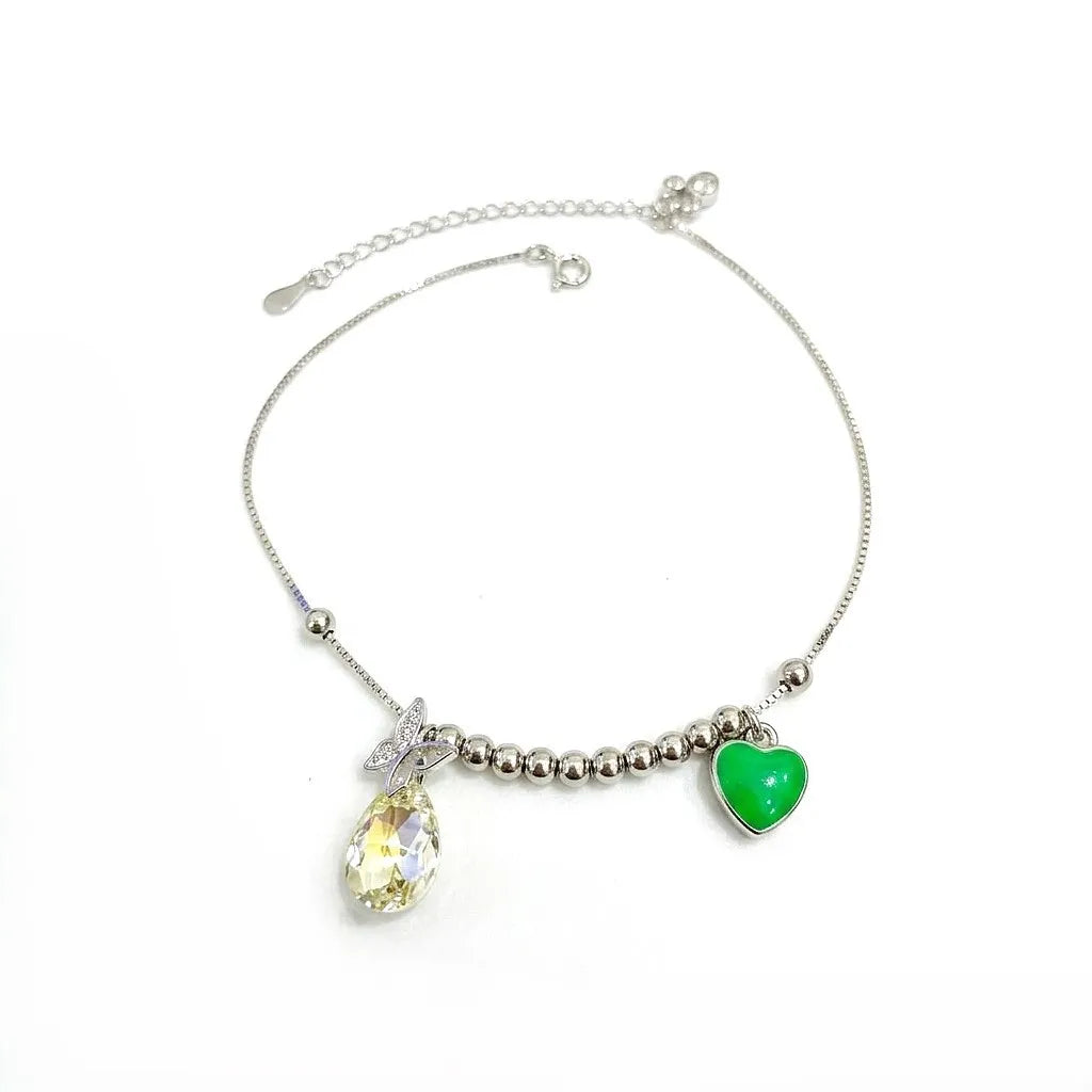 Marvel Silver Crystal Heart Anklet with sparkling teardrop crystal, green heart charm, silver bead detailing, and adjustable chain for women and girls.
