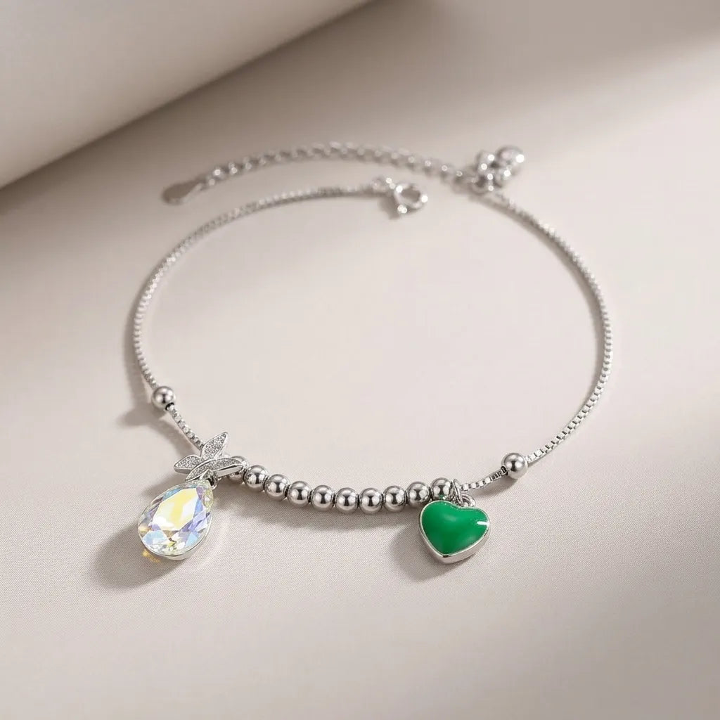 Marvel Silver Crystal Heart Anklet with sparkling teardrop crystal, green heart charm, silver bead detailing, and adjustable chain for women and girls.