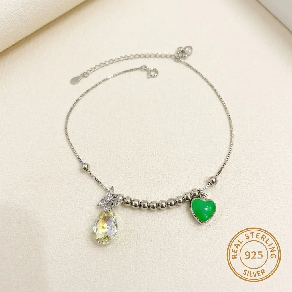Marvel Silver Crystal Heart Anklet with sparkling teardrop crystal, green heart charm, silver bead detailing, and adjustable chain for women and girls.