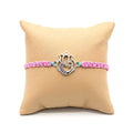 Marvel Silver Designer Ganesh Rakhi with silver-finish Lord Ganesha charm, pink braided thread, and sparkling stone detailing for Raksha Bandhan.