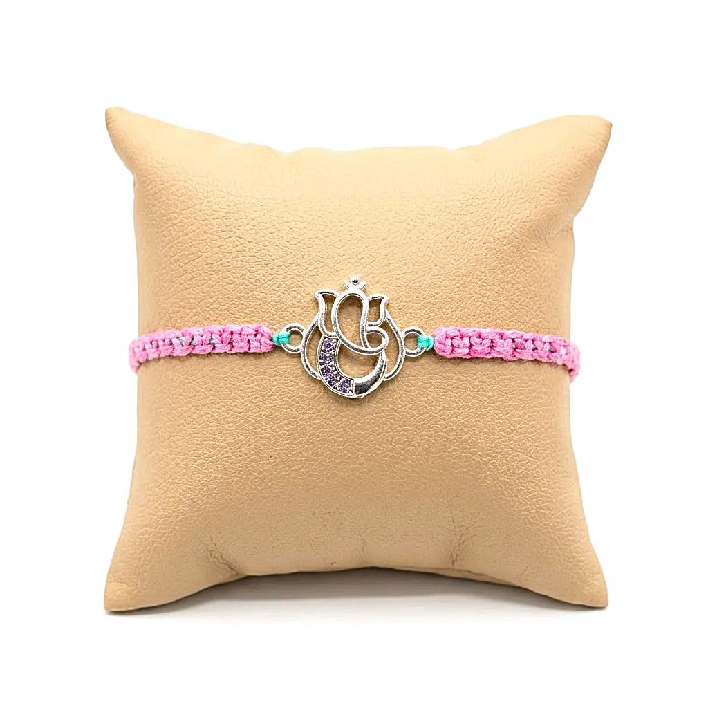 Marvel Silver Designer Ganesh Rakhi with silver-finish Lord Ganesha charm, pink braided thread, and sparkling stone detailing for Raksha Bandhan.