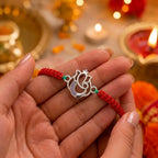 Marvel Silver Designer Ganesh Rakhi with silver-finish Lord Ganesha charm, pink braided thread, and sparkling stone detailing for Raksha Bandhan.
