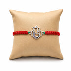 Marvel Silver Designer Ganesh Rakhi with silver-finish Lord Ganesha charm, pink braided thread, and sparkling stone detailing for Raksha Bandhan.
