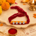 Marvel Silver Ganesh Designer Rakhi featuring four silver-finish Lord Ganesha charms on a handcrafted yellow and maroon braided thread for Raksha Bandhan.