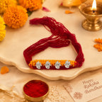 Marvel Silver Ganesh Designer Rakhi featuring four silver-finish Lord Ganesha charms on a handcrafted yellow and maroon braided thread for Raksha Bandhan.