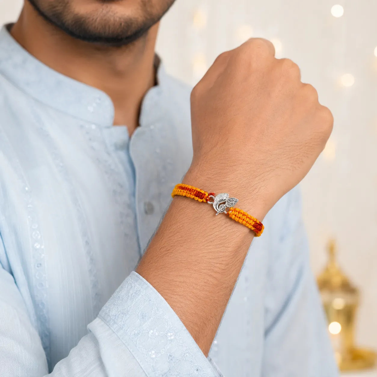 Marvel Silver Ganesh design rakhi with yellow and red braided thread for brother