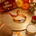 Marvel Silver Ganesh design rakhi with yellow and red braided thread for brother