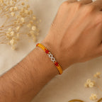 Marvel Silver infinity design rakhi for brother with yellow red braided thread and silver-tone stone-studded infinity charm