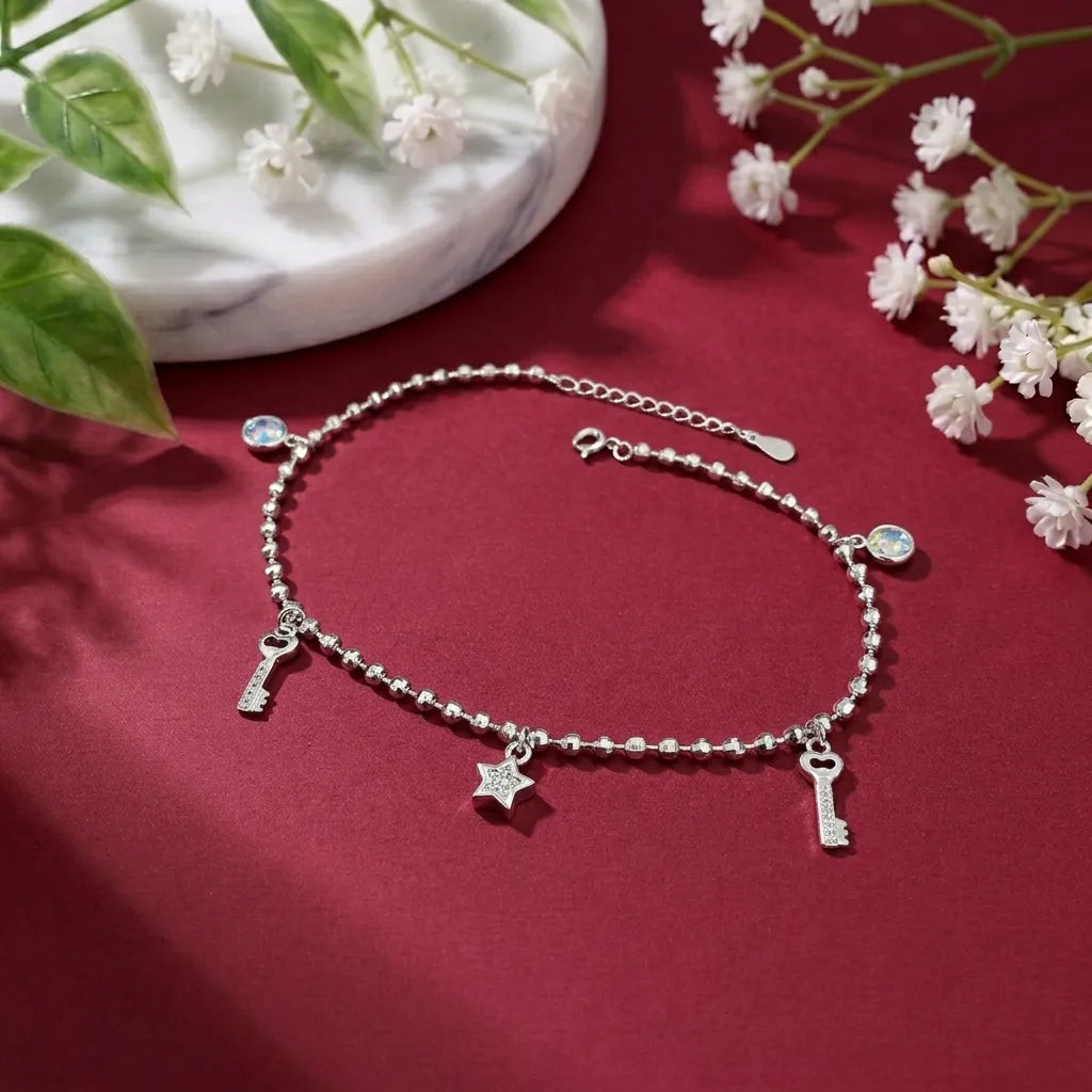 Marvel Silver Key Charm Anklet with polished silver bead chain, sparkling crystal accents, key charms, star charm, and adjustable extension chain for women and girls.