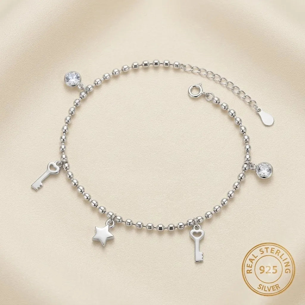 Marvel Silver Key Charm Anklet with polished silver bead chain, sparkling crystal accents, key charms, star charm, and adjustable extension chain for women and girls.