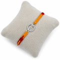 Marvel Silver Krishna name rakhi for brother with yellow red braided thread and silver-tone circular stone-style charm