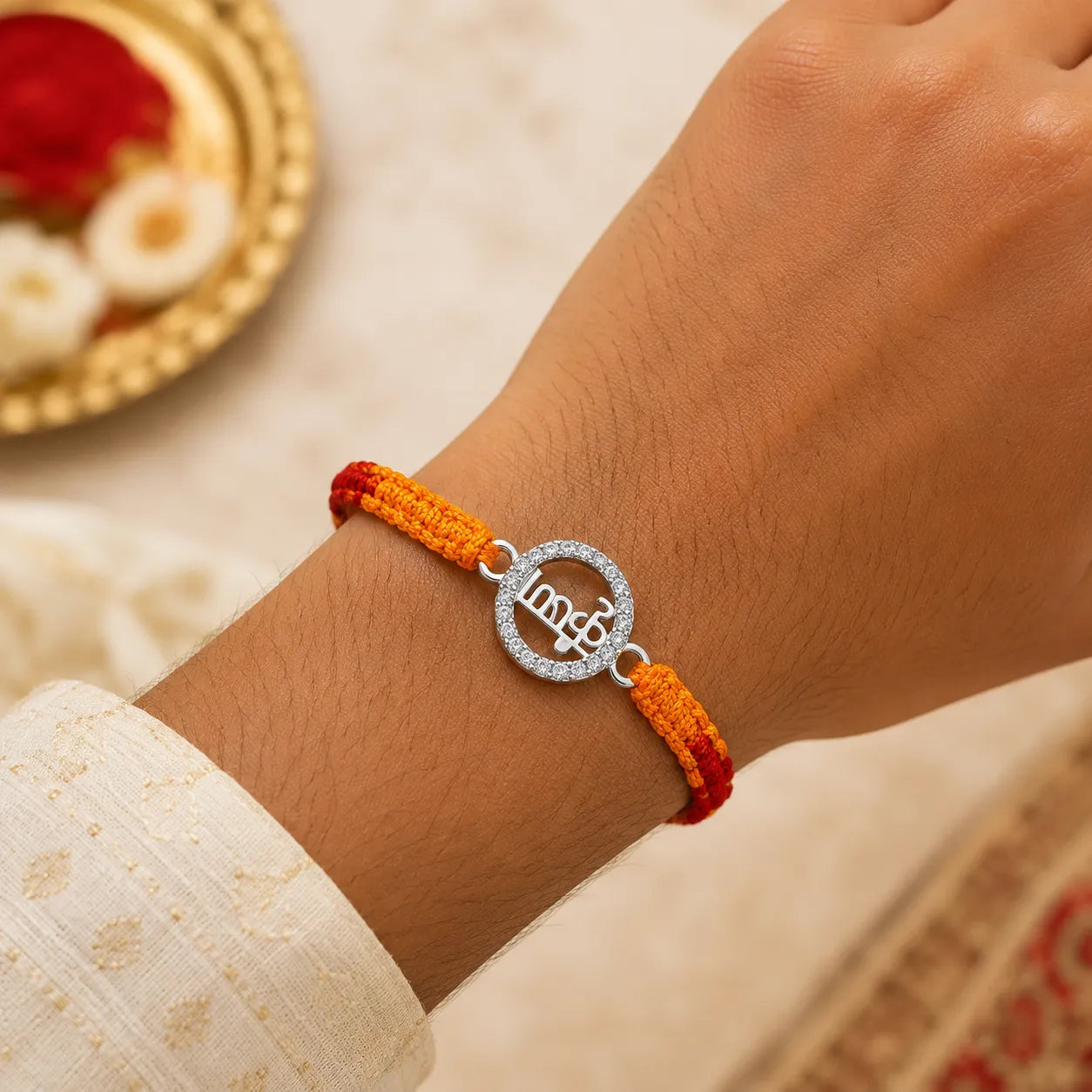 Marvel Silver Krishna name rakhi for brother with yellow red braided thread and silver-tone circular stone-style charm