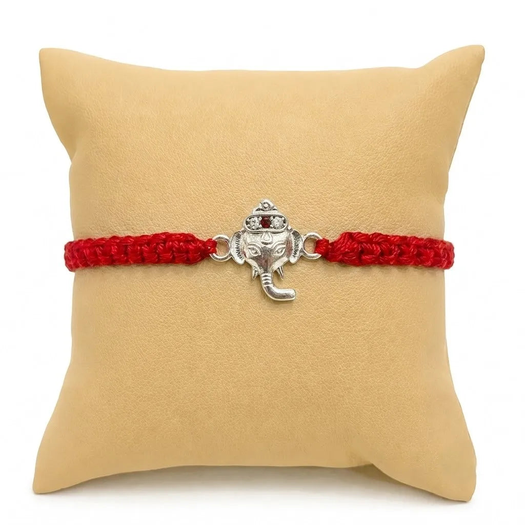 Marvel Silver Lord Ganesha Rakhi featuring a silver-finish Ganesh charm on a handcrafted red braided thread for Raksha Bandhan.