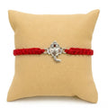 Marvel Silver Lord Ganesha Rakhi featuring a silver-finish Ganesh charm on a handcrafted red braided thread for Raksha Bandhan.