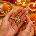 Marvel Silver Lord Ganesha Silver Rakhi with Orange and Yellow Woven Thread