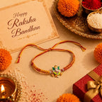 Marvel Silver Lord Ganesha Silver Rakhi with Orange and Yellow Woven Thread