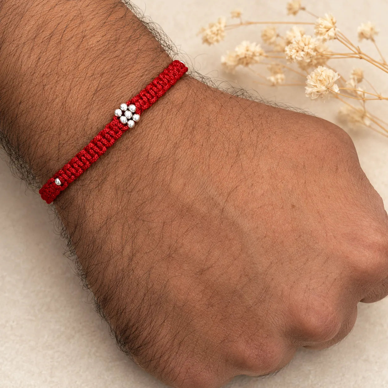 Marvel Silver minimal floral red thread rakhi for brother with silver-tone bead centre and accents