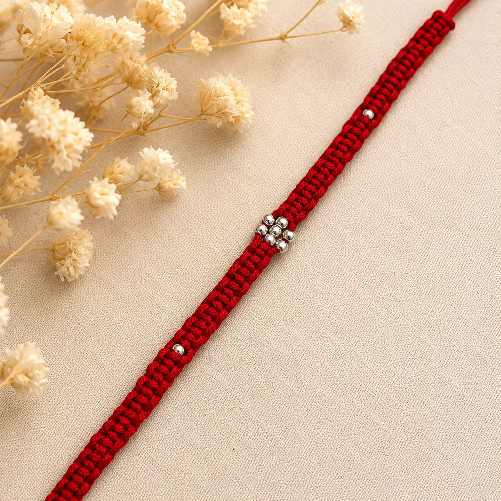 Marvel Silver minimal floral red thread rakhi for brother with silver-tone bead centre and accents