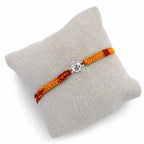 Marvel Silver Om design rakhi for brother with yellow red braided thread and silver-tone stone-studded charm