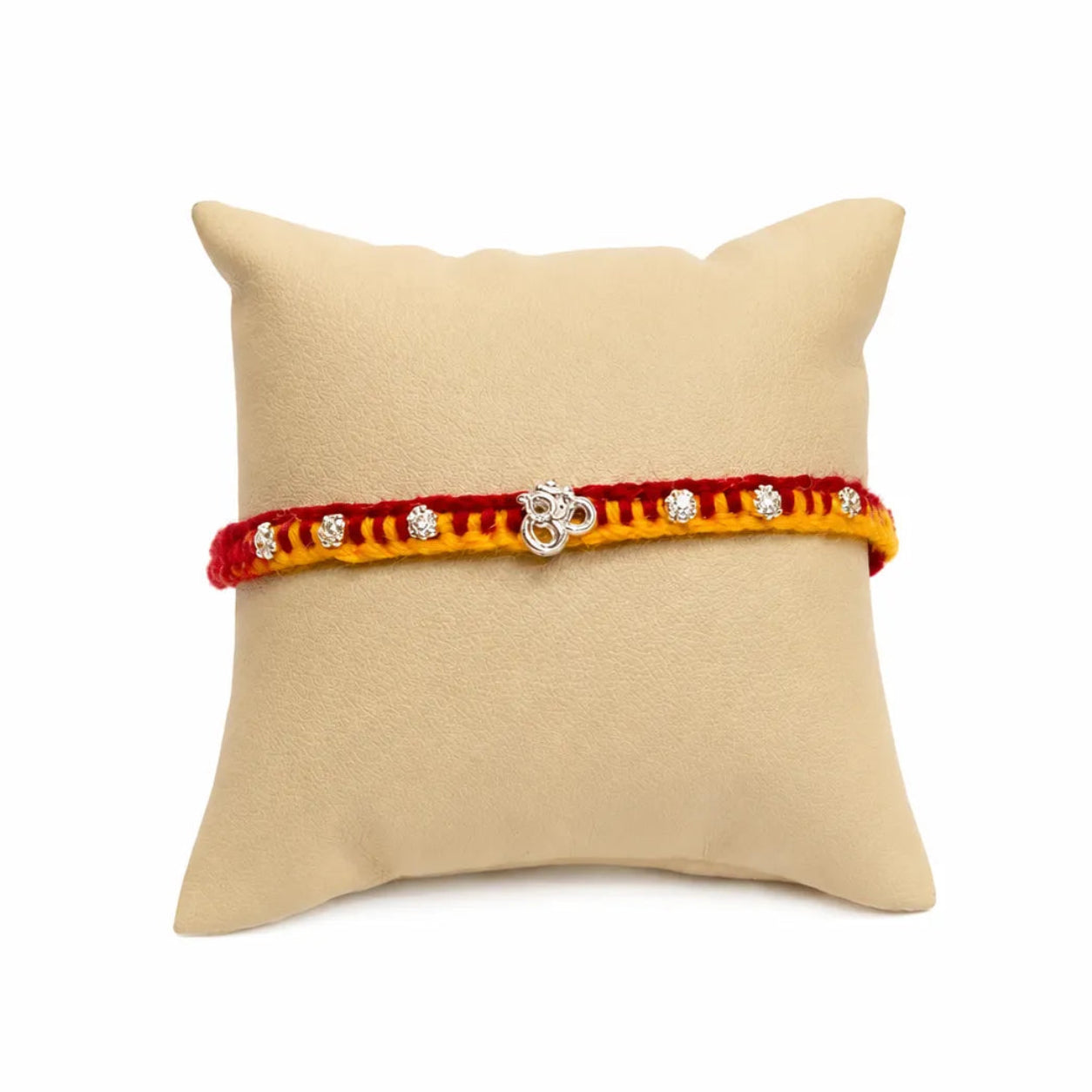 Marvel Silver Om Designer Rakhi featuring a silver-finish Om charm with crystal beads on a handcrafted red and yellow thread for Raksha Bandhan.