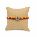 Marvel Silver Om Designer Rakhi with sparkling Om centerpiece, silver decorative beads, and red-yellow braided thread for Raksha Bandhan