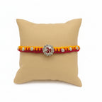 Marvel Silver Om Designer Rakhi with sparkling Om centerpiece, silver decorative beads, and red-yellow braided thread for Raksha Bandhan