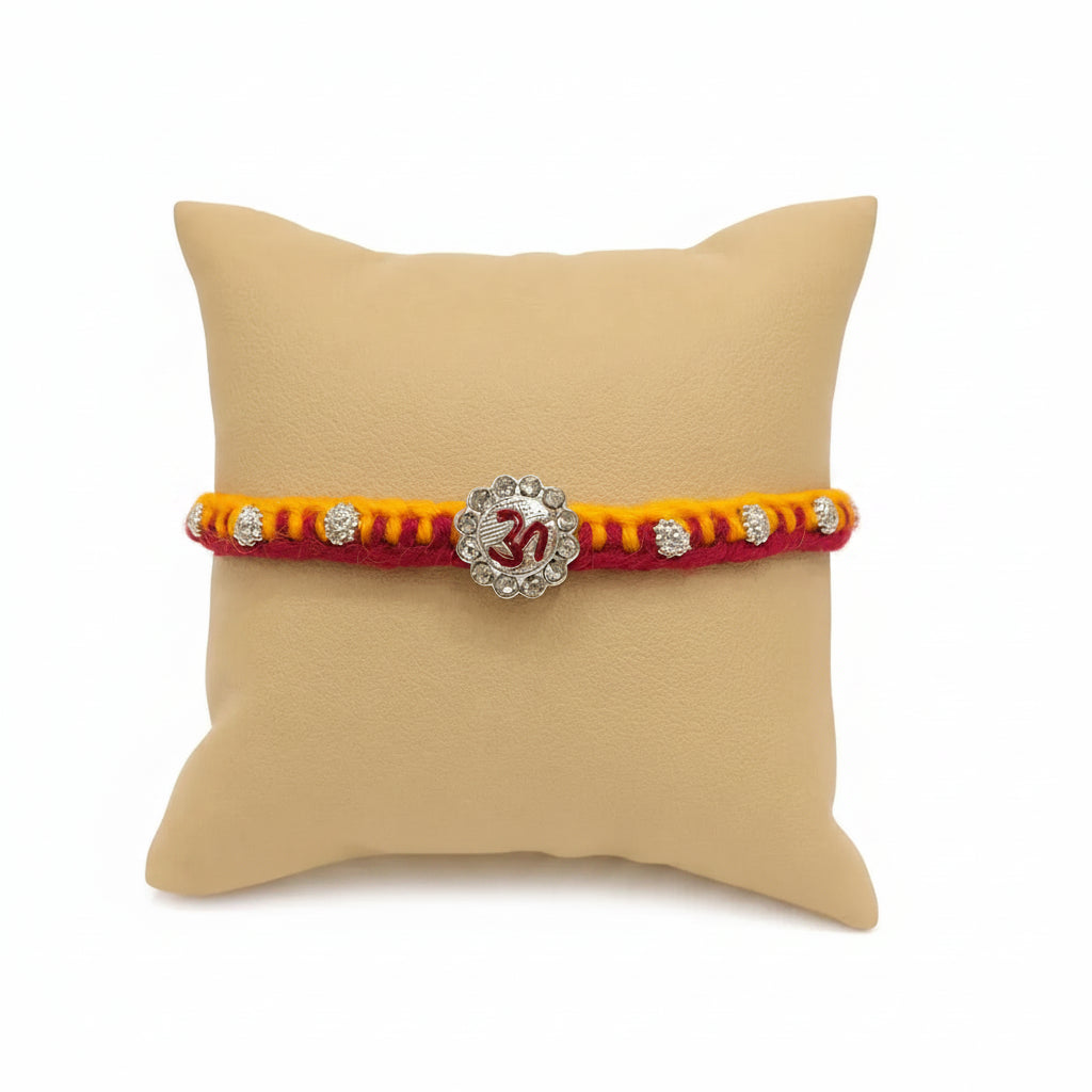 Marvel Silver Om Designer Rakhi with sparkling Om centerpiece, silver decorative beads, and red-yellow braided thread for Raksha Bandhan