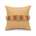 Marvel Silver Om & Lord Ganesha Designer Rakhi with stone-studded charms and handcrafted yellow maroon braided thread for Raksha Bandhan celebration.