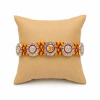 Marvel Silver Om & Lord Ganesha Designer Rakhi with stone-studded charms and handcrafted yellow maroon braided thread for Raksha Bandhan celebration.