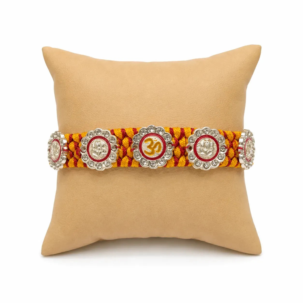 Marvel Silver Om & Lord Ganesha Designer Rakhi with stone-studded charms and handcrafted yellow maroon braided thread for Raksha Bandhan celebration.
