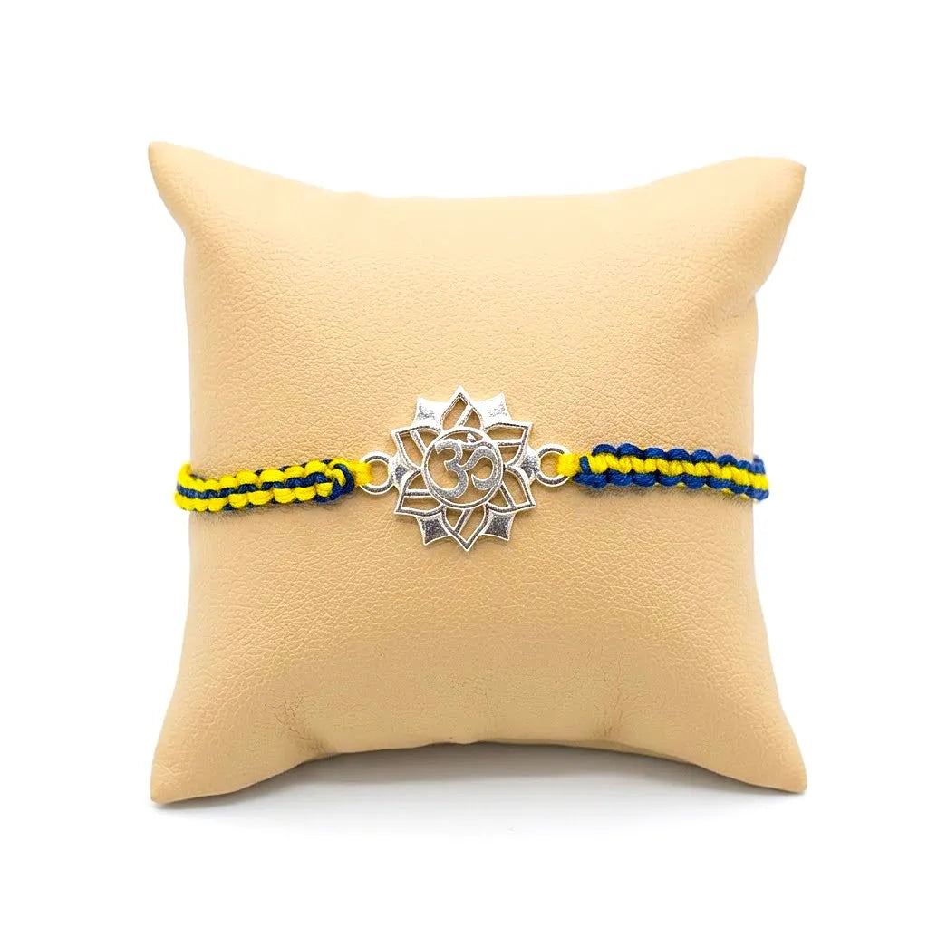 Marvel Silver Om Lotus Rakhi with silver finish Om symbol and blue yellow handcrafted thread for Raksha Bandhan.