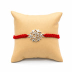 Marvel Silver Om Lotus Rakhi with silver finish Om symbol and blue yellow handcrafted thread for Raksha Bandhan.