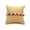 Marvel Silver handcrafted Om & Swastik designer Rakhi with traditional red and yellow braided thread for Raksha Bandhan.