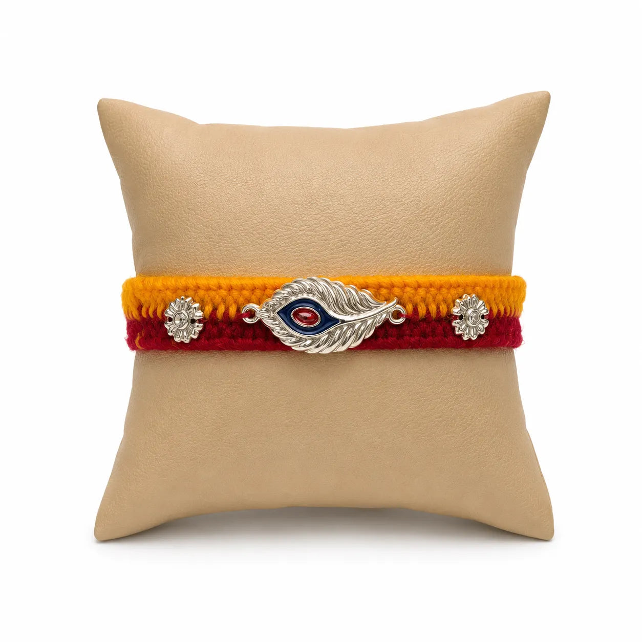 Marvel Silver designer silver peacock feather rakhi with red stone centerpiece and handcrafted yellow and red cotton thread for Raksha Bandhan.