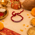 Marvel Silver red braided rakhi for brother with silver-tone bead centre design
