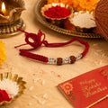 Marvel Silver red Rudraksha rakhi bracelet for men with silver-tone beads and braided thread
